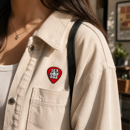 Enamel pin featuring a bold "Boom Goes the Rebel" design with a bomb illustration, crafted by Pinlord.com.