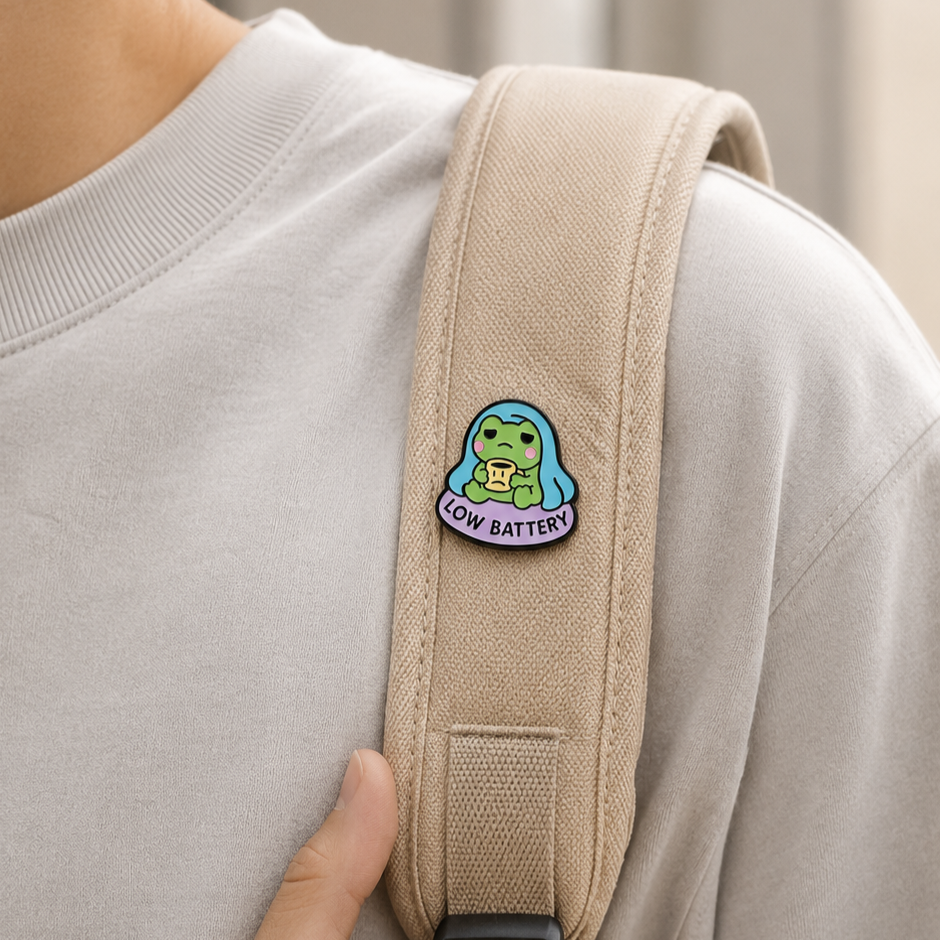 Cute Low Battery Frog enamel pin featuring a green frog with a low battery symbol, perfect for pin collectors and frog enthusiasts.