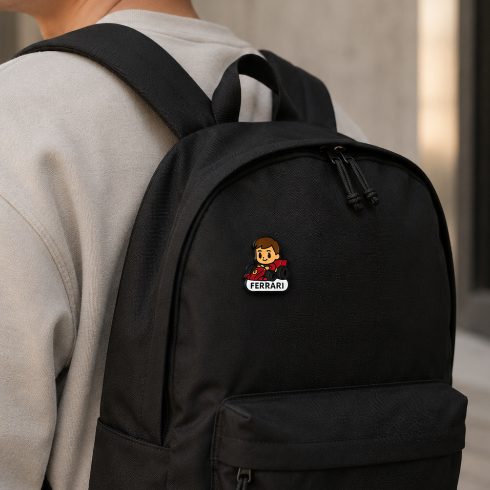 Scarlet Prince Charles Leclerc enamel pin featuring a racing car design, detailed with vibrant red and black colors.