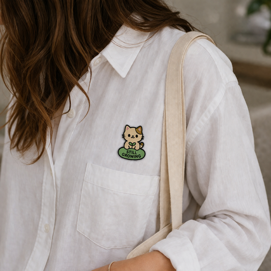 Still Growing Cat enamel pin featuring a cute feline design, perfect for cat lovers and enamel pin collectors.