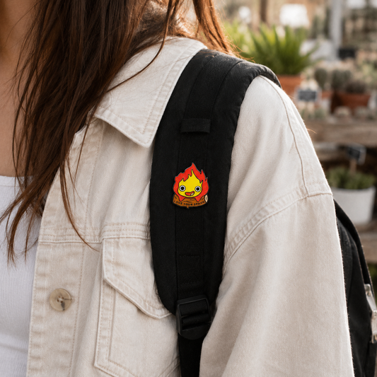 Calcifer enamel pin from Love my Spark collection, featuring a fiery design on a detailed metal pin.