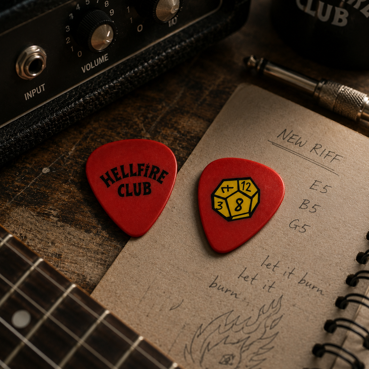Red Hellfire Club D12 guitar pick from Pinlord.com, featuring a fiery demon design and durable material for guitar playing.