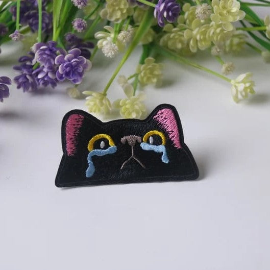 Custom patches from Pinlord.com featuring vibrant embroidered designs on fabric for clothing or accessories.