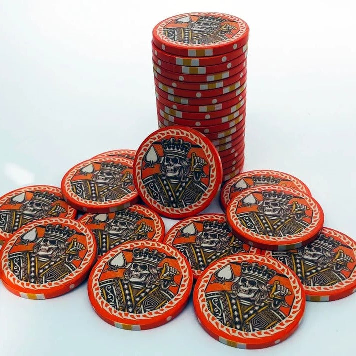 Set of custom poker chips featuring unique designs, made by Pinlord.com, perfect for poker games and gambling events.