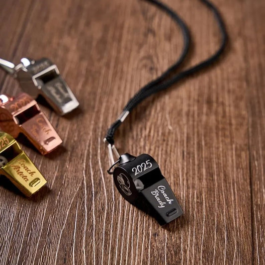 Custom Pinlord.com whistle with engraved design, made of metal, featuring a loop for attaching to keychains or lanyards.