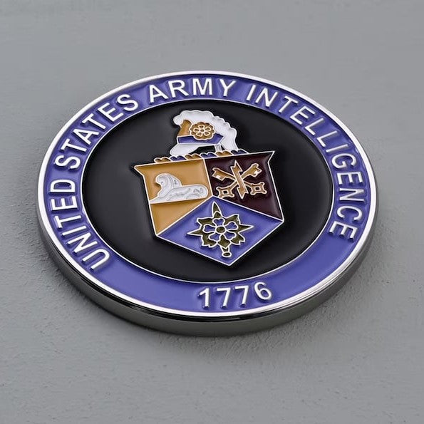 Custom coins from Pinlord.com featuring personalized designs and detailed craftsmanship on a polished metal surface.