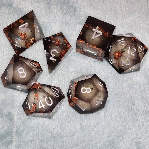 Custom gaming dice set by Pinlord.com featuring colorful, engraved polyhedral dice for tabletop role-playing games.