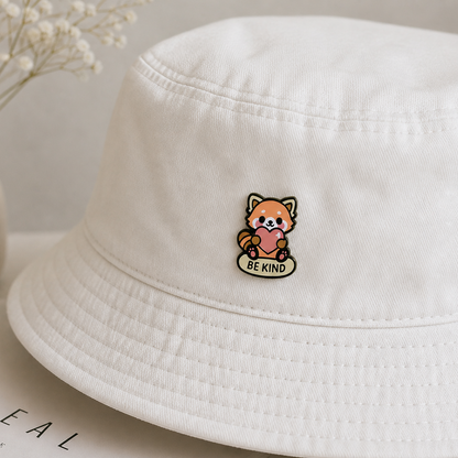 Red panda enamel pin from Pinlord.com featuring a "Be Kind" design, with vibrant colors and detailed craftsmanship.