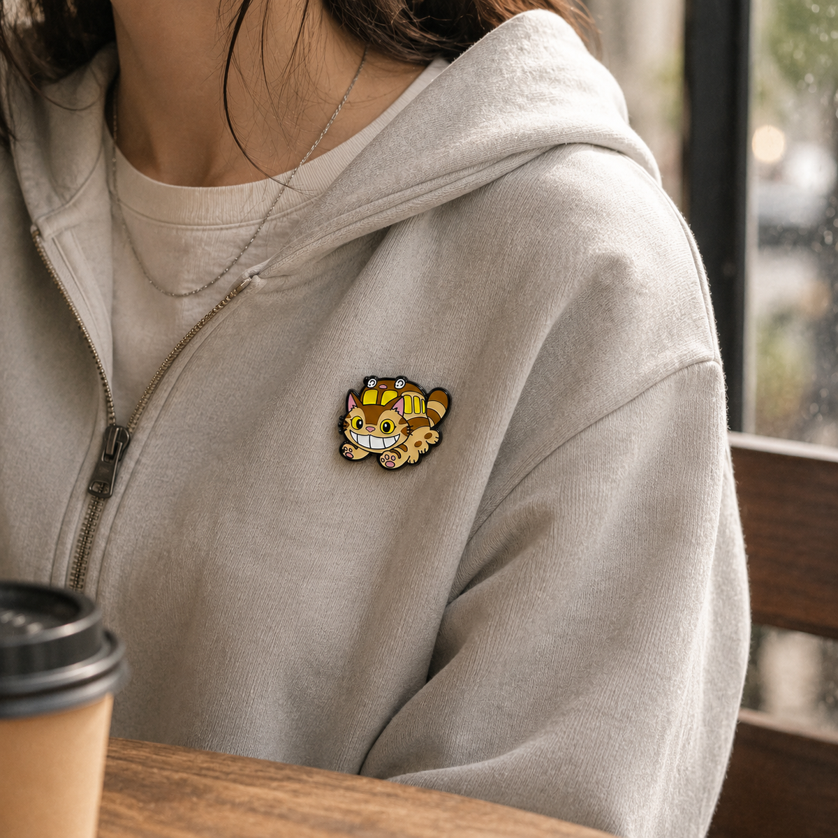 Close-up of a grinning Catbus companion enamel pin featuring vibrant colors and detailed design, perfect for pin collectors.