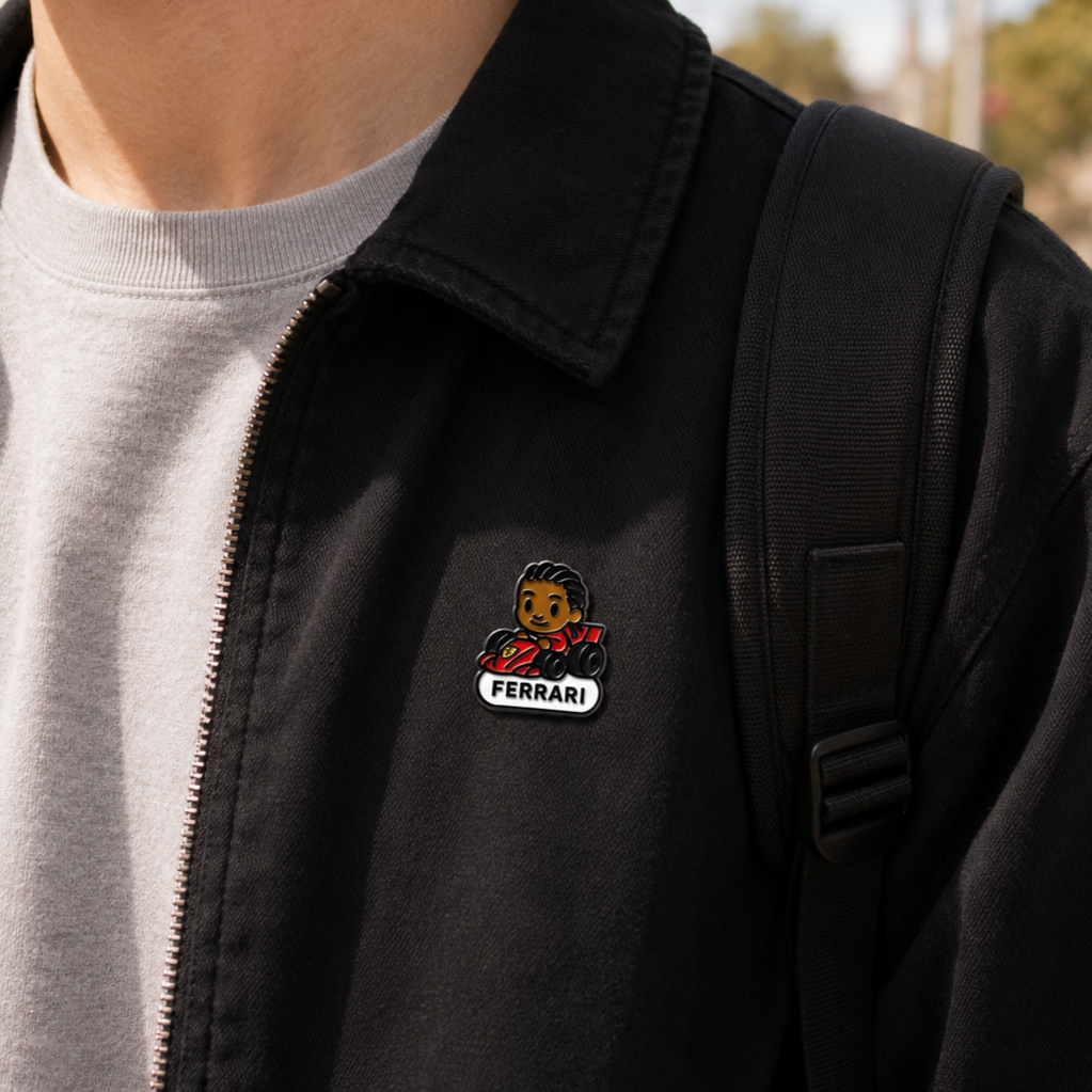 Close-up of the Legendary Lewis Hamilton enamel pin, featuring detailed design and vibrant colors on a black background.