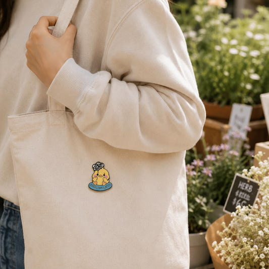 Overstimulated Chick enamel pin featuring a cute, colorful chick with wide eyes, pinned on a white background.
