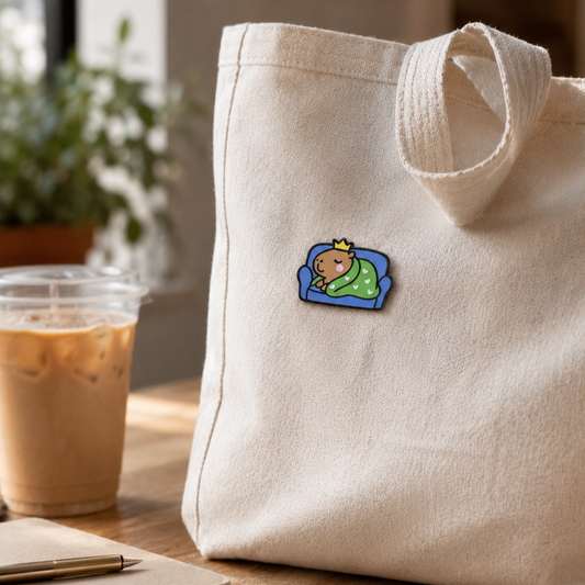 Sleepy Capybara enamel pin from Pinlord.com featuring a cute, relaxed capybara with closed eyes and a peaceful expression.