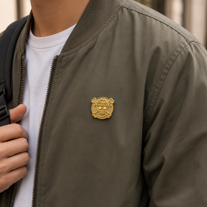 24k gold pirate flag enamel pin from Pinlord.com, featuring detailed pirate design on a shiny gold background.