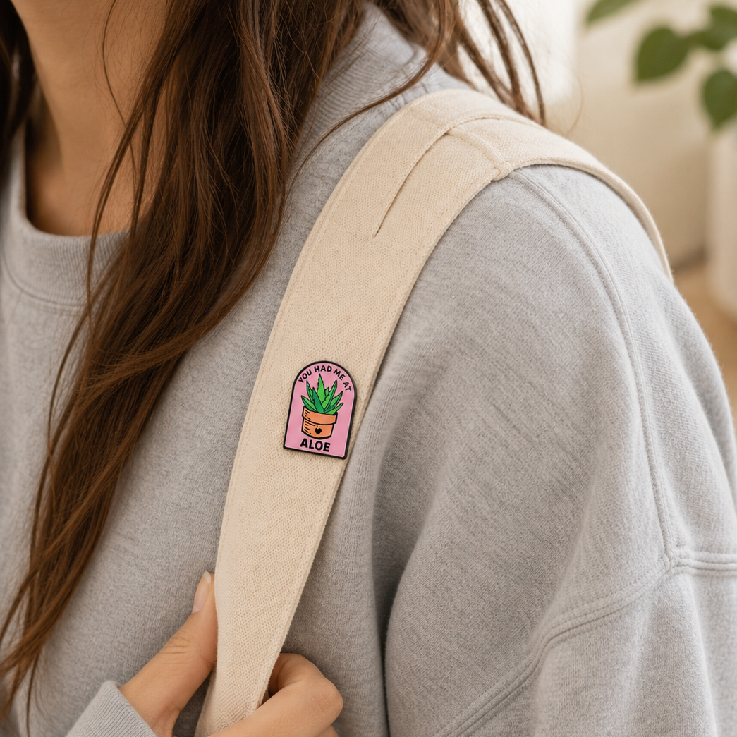 Aloe plant enamel pin by Pinlord.com featuring a cute green aloe leaf design on a metal pinback.