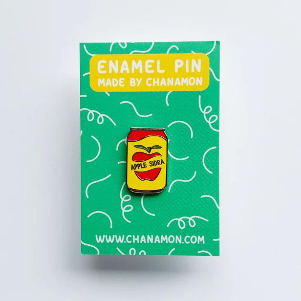 Custom enamel pins by Pinlord.com featuring colorful, detailed designs on a shiny metal surface.