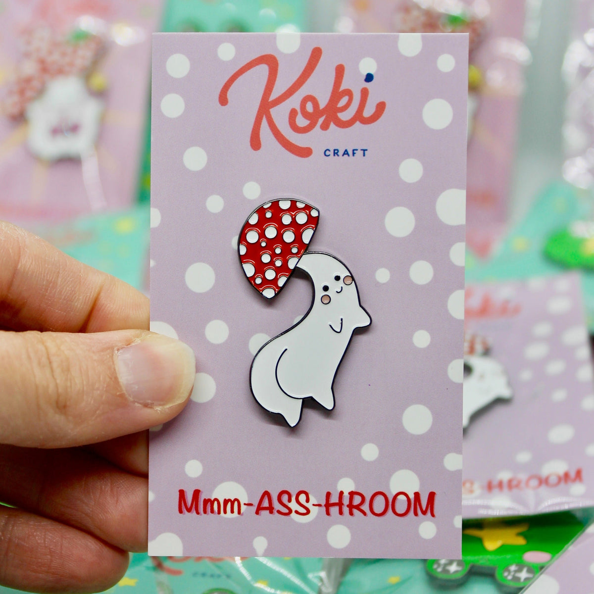 Custom enamel pins featuring unique designs from Pinlord.com, shown in a variety of colors and shapes.