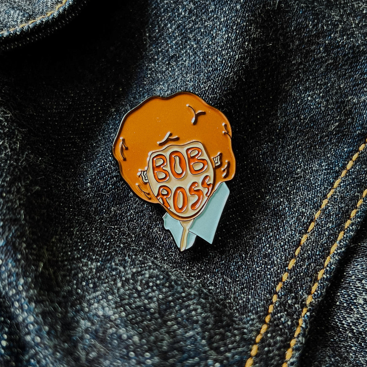 Custom enamel pins from Pinlord.com featuring colorful, detailed designs on silver metal with butterfly clutch back.