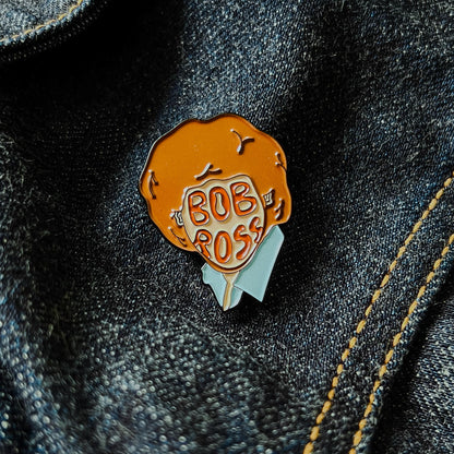 Custom enamel pins from Pinlord.com featuring colorful, detailed designs on silver metal with butterfly clutch back.