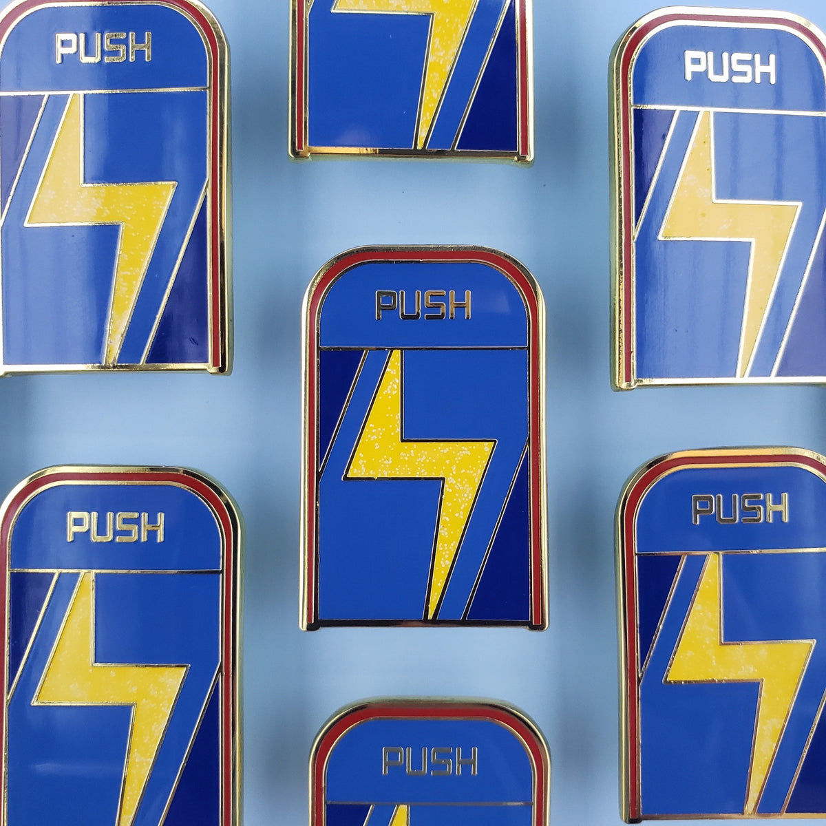 Custom enamel pins from Pinlord.com featuring colorful, handcrafted designs on a metal pin backing.