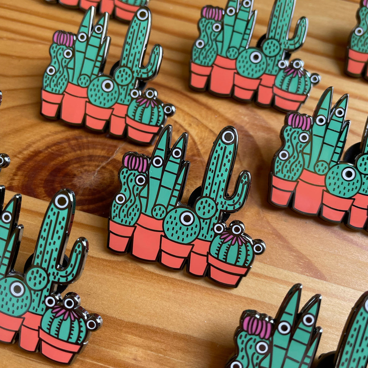 Custom enamel pins by Pinlord.com featuring colorful, detailed designs on a metal backing.