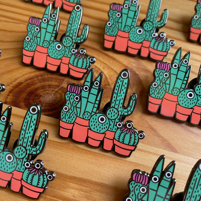 Custom enamel pins by Pinlord.com featuring colorful, detailed designs on a metal backing.
