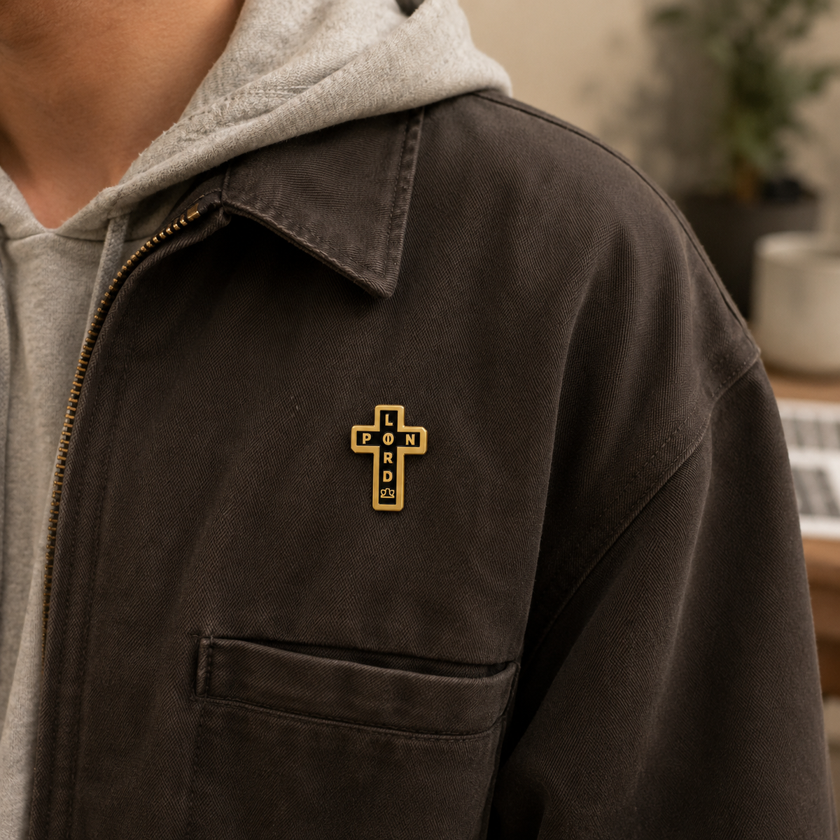 Enamel pin featuring a black cross design from Pin Lord, detailed metal edges and vibrant enamel finish.