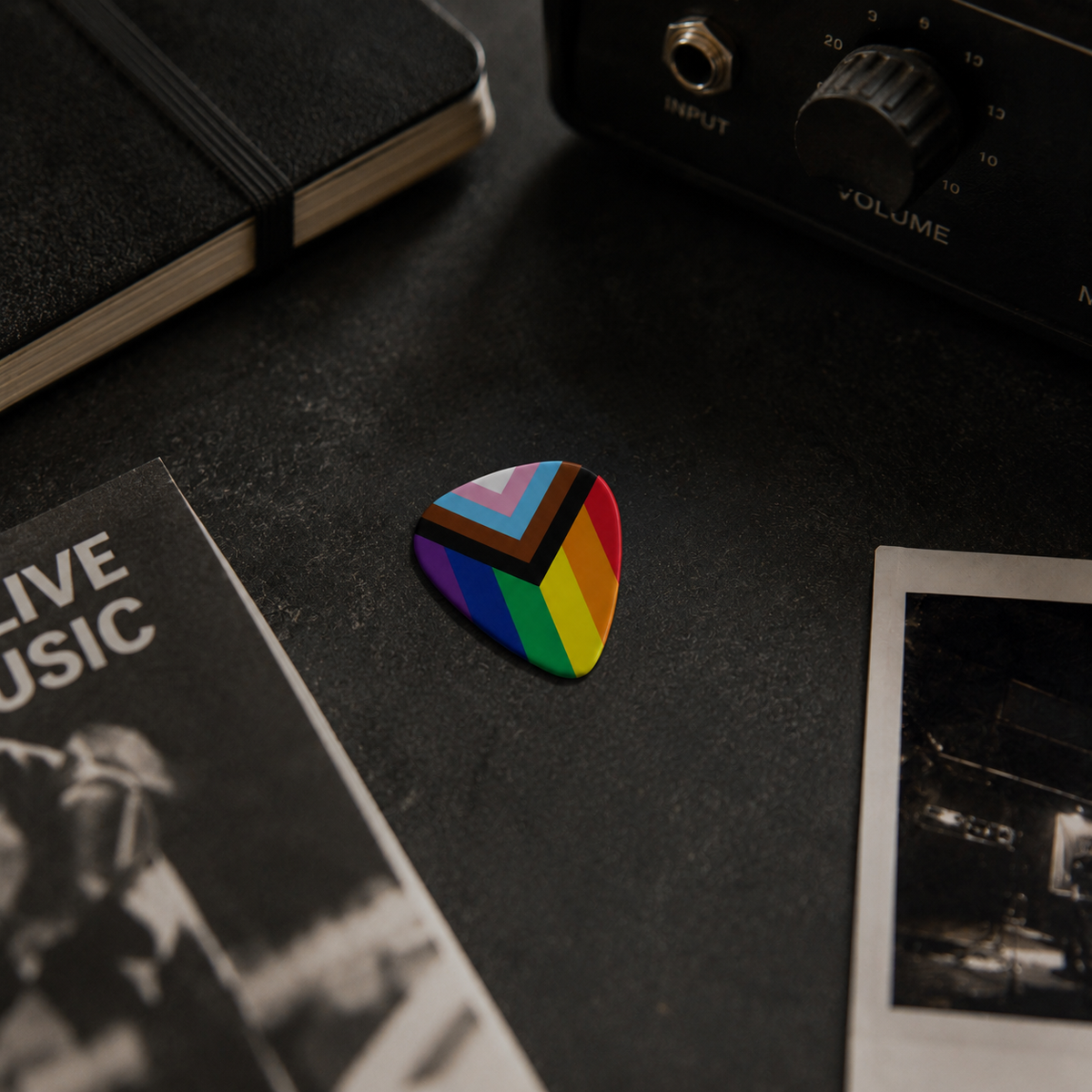Colorful "Love for Everyone" guitar pick by Pinlord.com featuring a rainbow heart design, made of durable material.