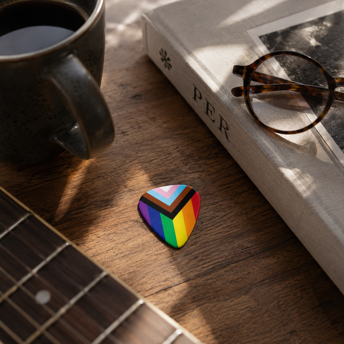Colorful "Love for Everyone" guitar pick by Pinlord.com featuring rainbow heart design, ideal for guitar players and music enthusiasts.
