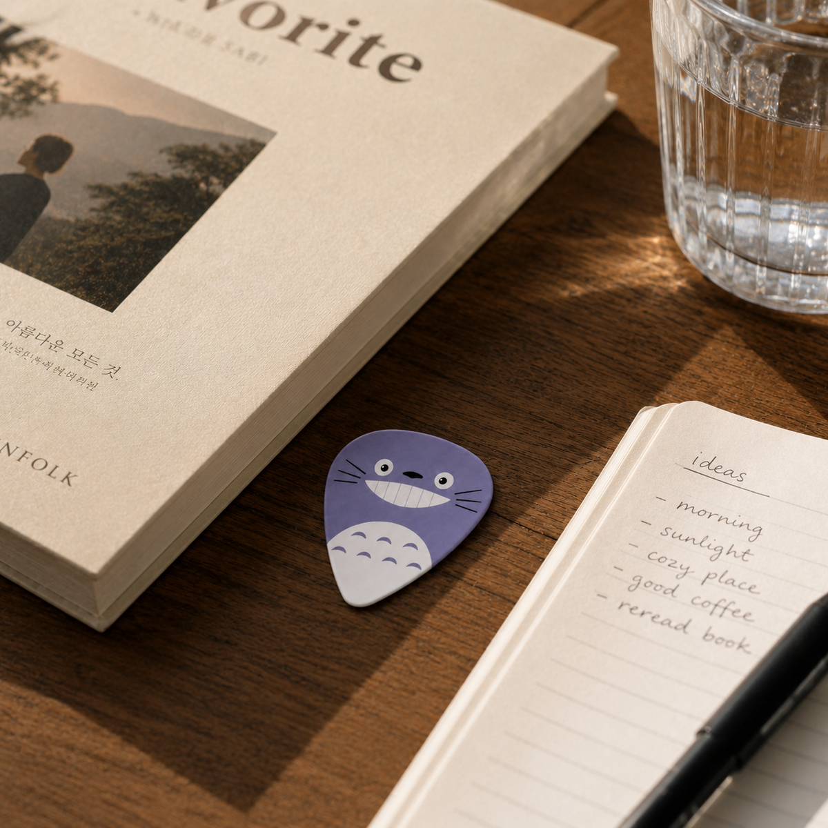 Green Totoro guitar pick from Pinlord.com with detailed Totoro character design, ideal for guitar players.