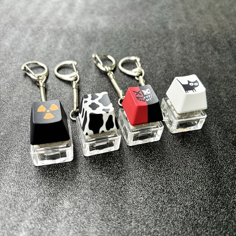 Custom keycap keychains featuring colorful, detailed designs from Pinlord.com, showcasing unique keycap accessories.