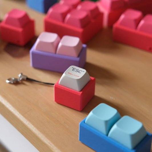 Custom keycap keychains featuring colorful, detailed keycap designs attached to key rings, perfect for keyboard enthusiasts.