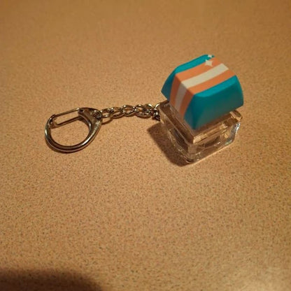 Custom keycap keychain featuring colorful, miniature keycap designs, perfect for key organizers and collectibles.
