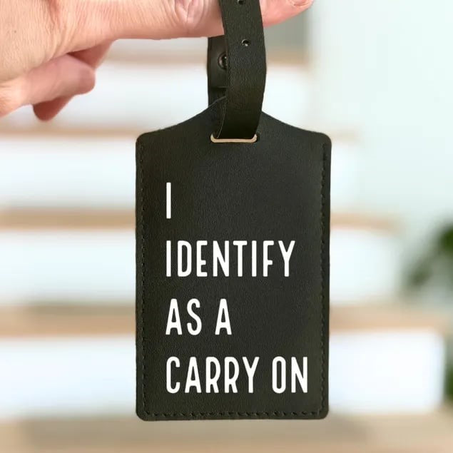 Custom luggage tag from Pinlord.com featuring a colorful design and durable strap for easy identification of travel bags.