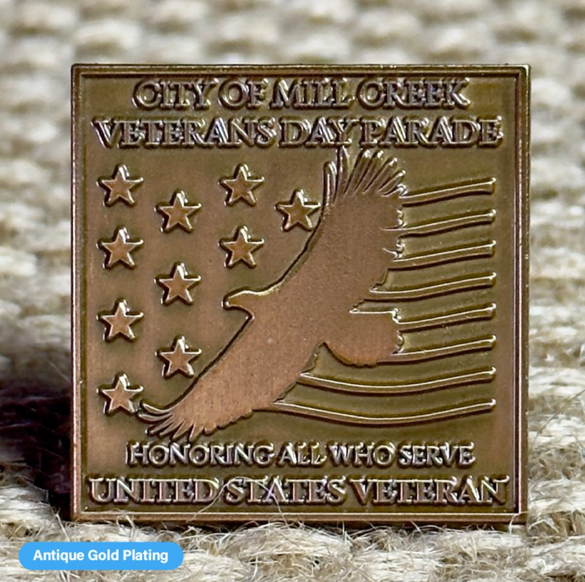 Close-up of a Pinlord.com lapel pin featuring the Now Review design on a suit lapel.