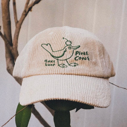 Close-up of a custom cap featuring the Mello Review design by Pinlord.com, showcasing detailed artwork on the fabric.