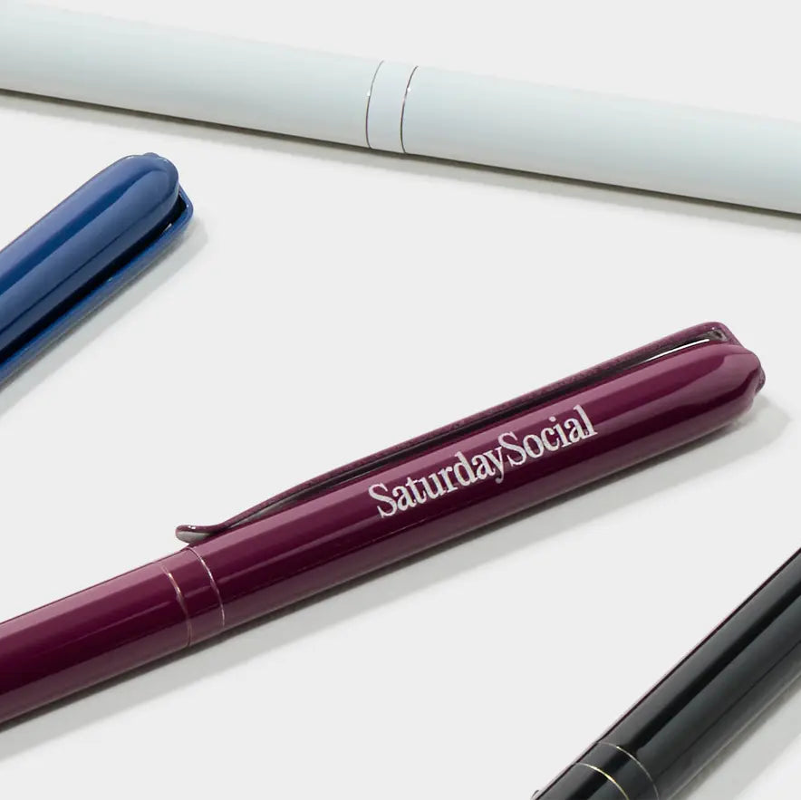 Close-up of a custom pen with "MOO Review" branding, featuring a sleek design and metallic finish from Pinlord.com.