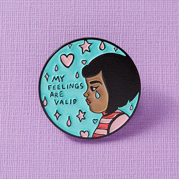 Close-up of a colorful enamel pin from Pinlord.com, featuring a punk-inspired design with intricate details and vibrant colors.