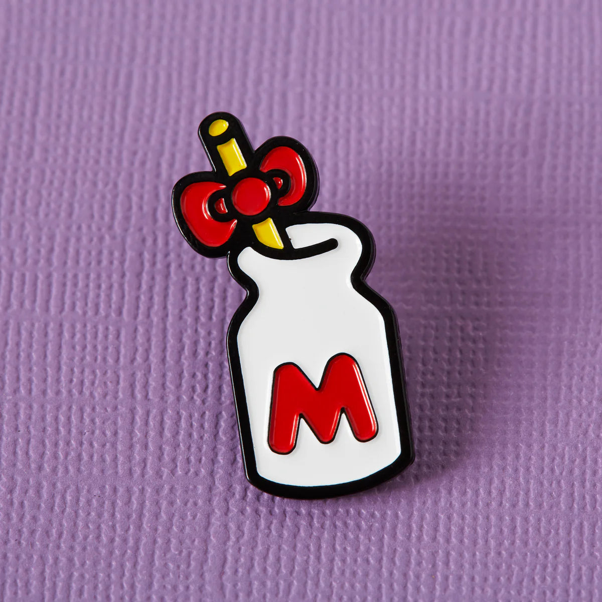 Close-up of a colorful enamel pin featuring punk-inspired design from Pinlord.com, showcasing detailed craftsmanship.