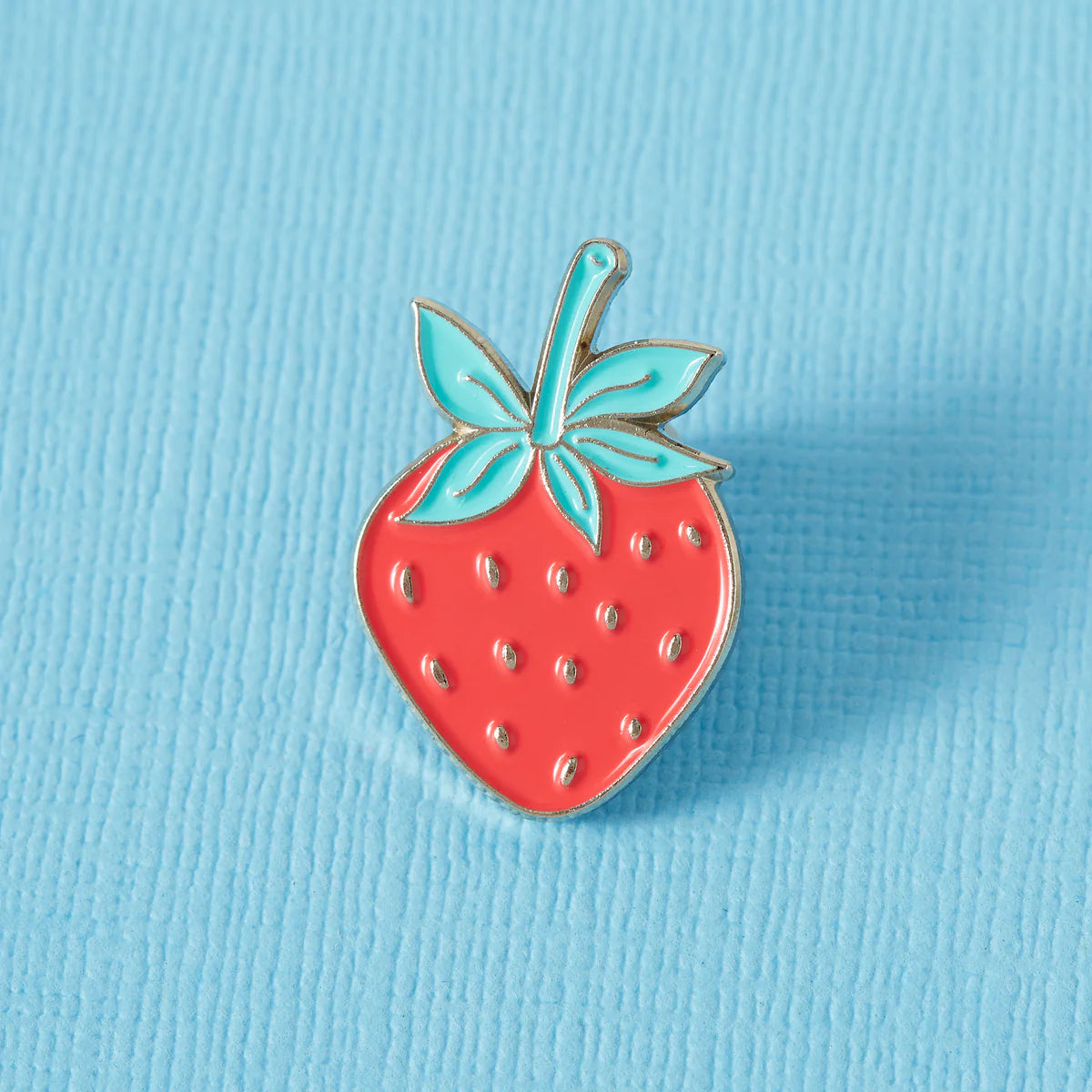 Close-up of a colorful enamel pin featuring punk-inspired design, manufactured by Pinlord.com for The Enamel Pin Factory Review.