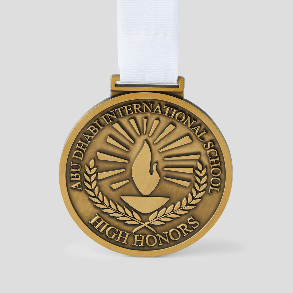 Pinlord.com THE/STUDIO Review manufacturer medal with engraved design and branding on a metallic finish.