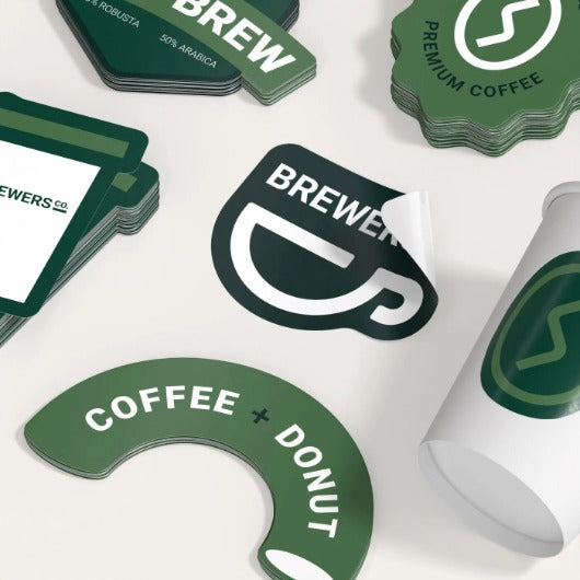 Sheet of custom stickers with Pinlord.com branding from UPrinting manufacturer, showcasing colorful printed designs.