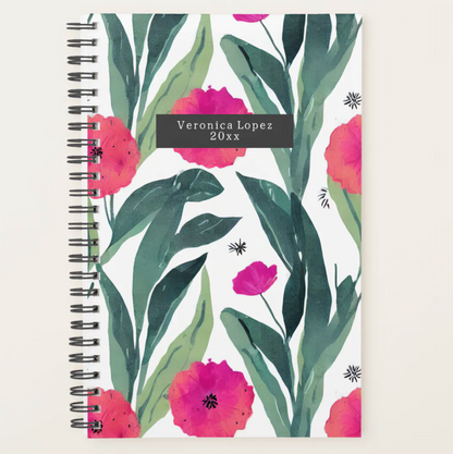 A Zazzle notebook featuring a design with the Pinlord.com brand logo, open to show lined pages on a wooden desk.