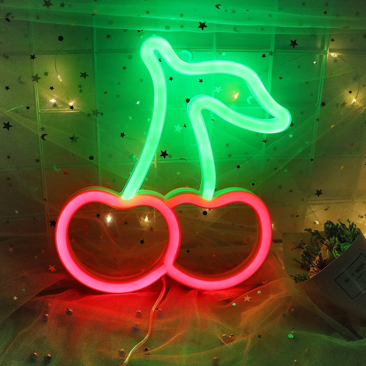 Custom neon sign with pink and blue glowing letters, mounted on a dark wall, showcasing vibrant, personalized LED neon lighting.
