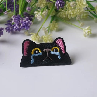 Custom patches from Pinlord.com featuring vibrant embroidered designs on fabric for clothing or accessories.