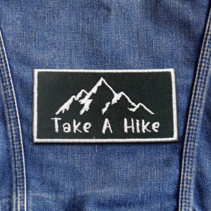 Close-up of colorful custom patches featuring various embroidered designs, ideal for clothing and accessories.