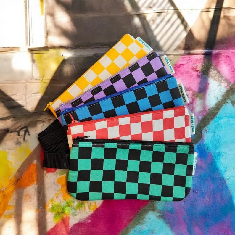 Custom pencil case from Pinlord.com featuring colorful fabric and zipper closure, designed for storing pens and pencils.