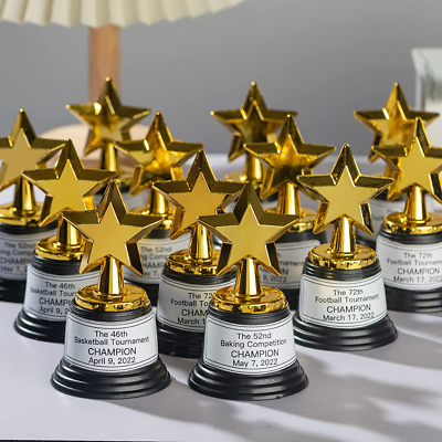 Custom trophies with engraved plaques, featuring a classic award design, displayed on a wooden base, from Pinlord.com.