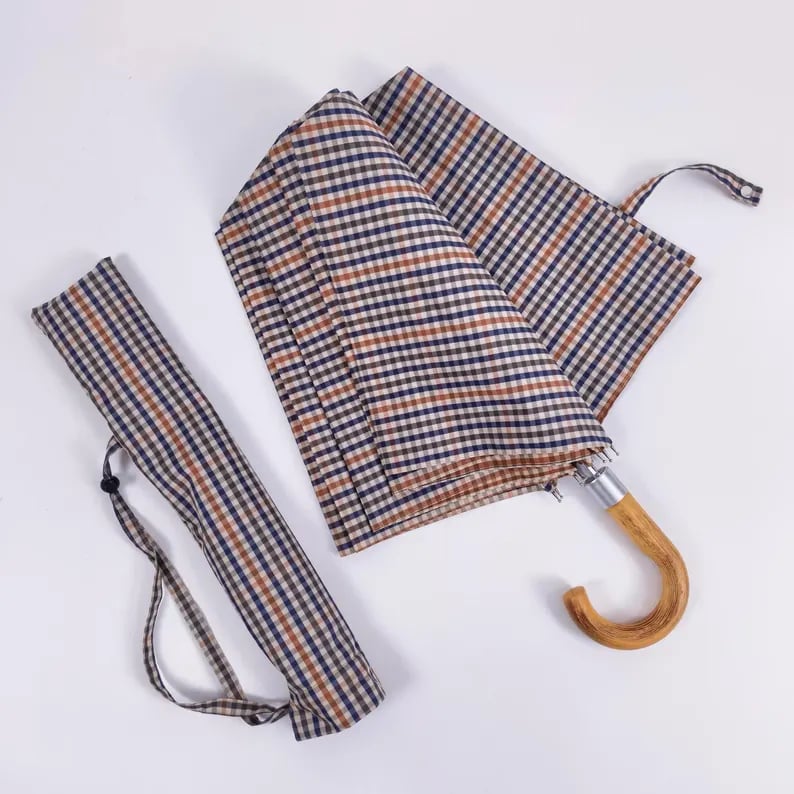 Custom umbrella by Pinlord.com featuring vibrant, waterproof fabric with a sturdy handle and colorful design.