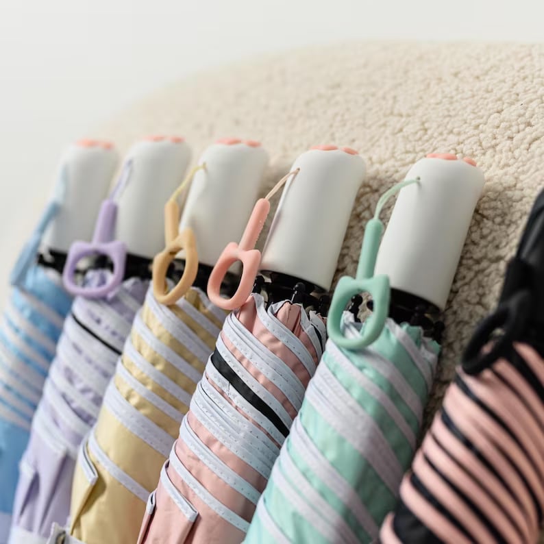 Custom Pinlord.com umbrella with colorful, patterned fabric and sturdy handle, designed for personalized rain protection.
