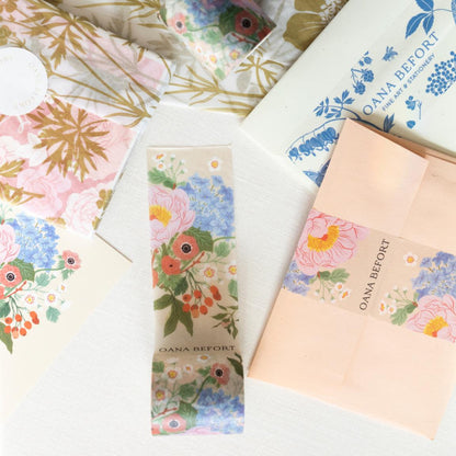 Custom Washi Tape by Pinlord.com featuring colorful, patterned designs on a roll of decorative adhesive tape.